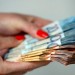 13706166-Woman-holding-euro-money-banknotes-concept-of-stealing-cash-rich-people-savings-or-spending-money-counting